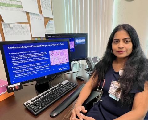 Geetha Sivasubramanian, MD, sitting next to computer screen