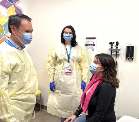 Doctor and medical resident talk to patient 