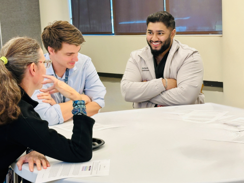 Physicians sitting around a table at new fellows orientation at UCSF Fresno