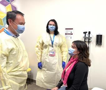 Doctor and medical resident talk to patient 
