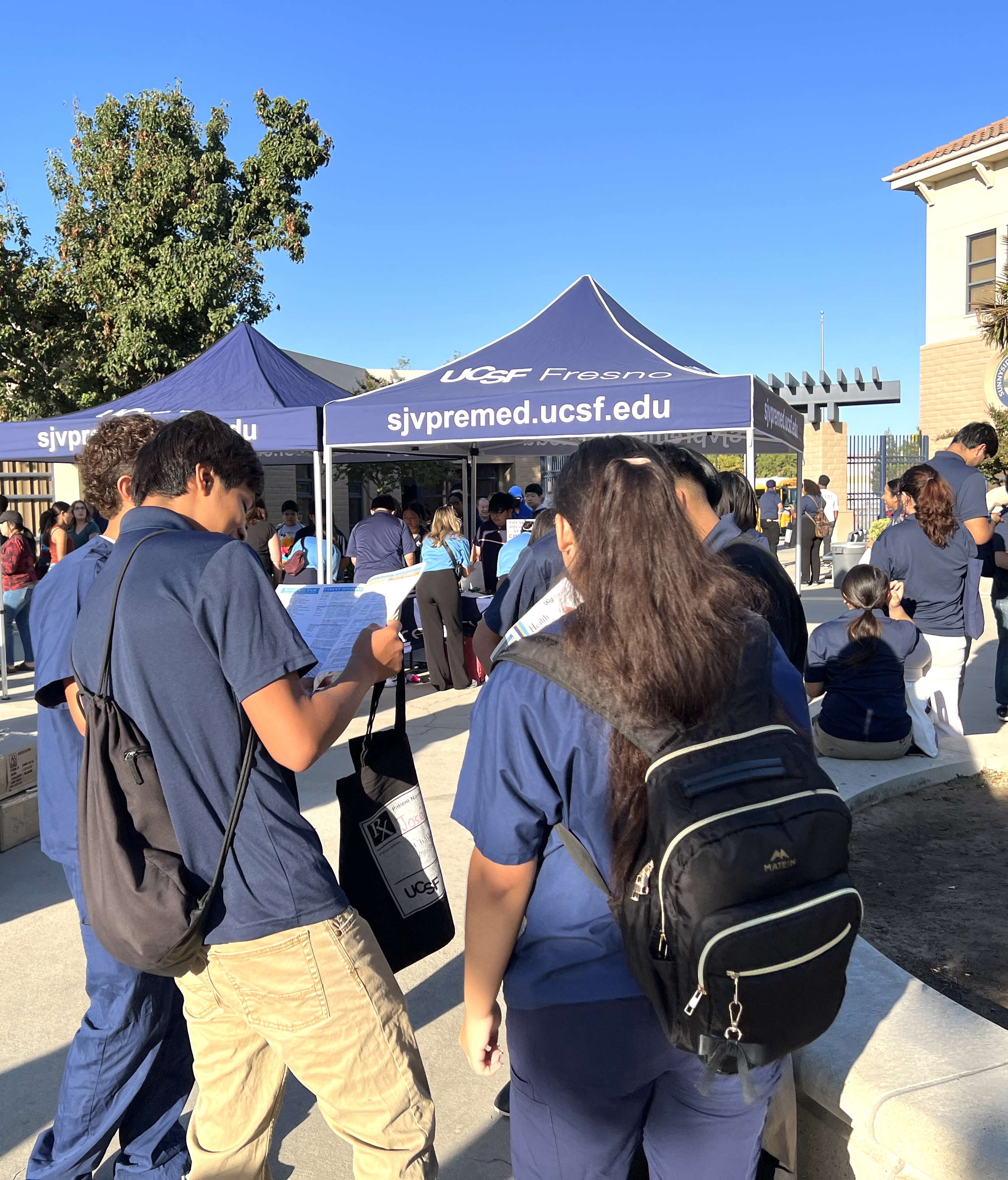 Group of students reviewing information provided at ROAD Conference event.