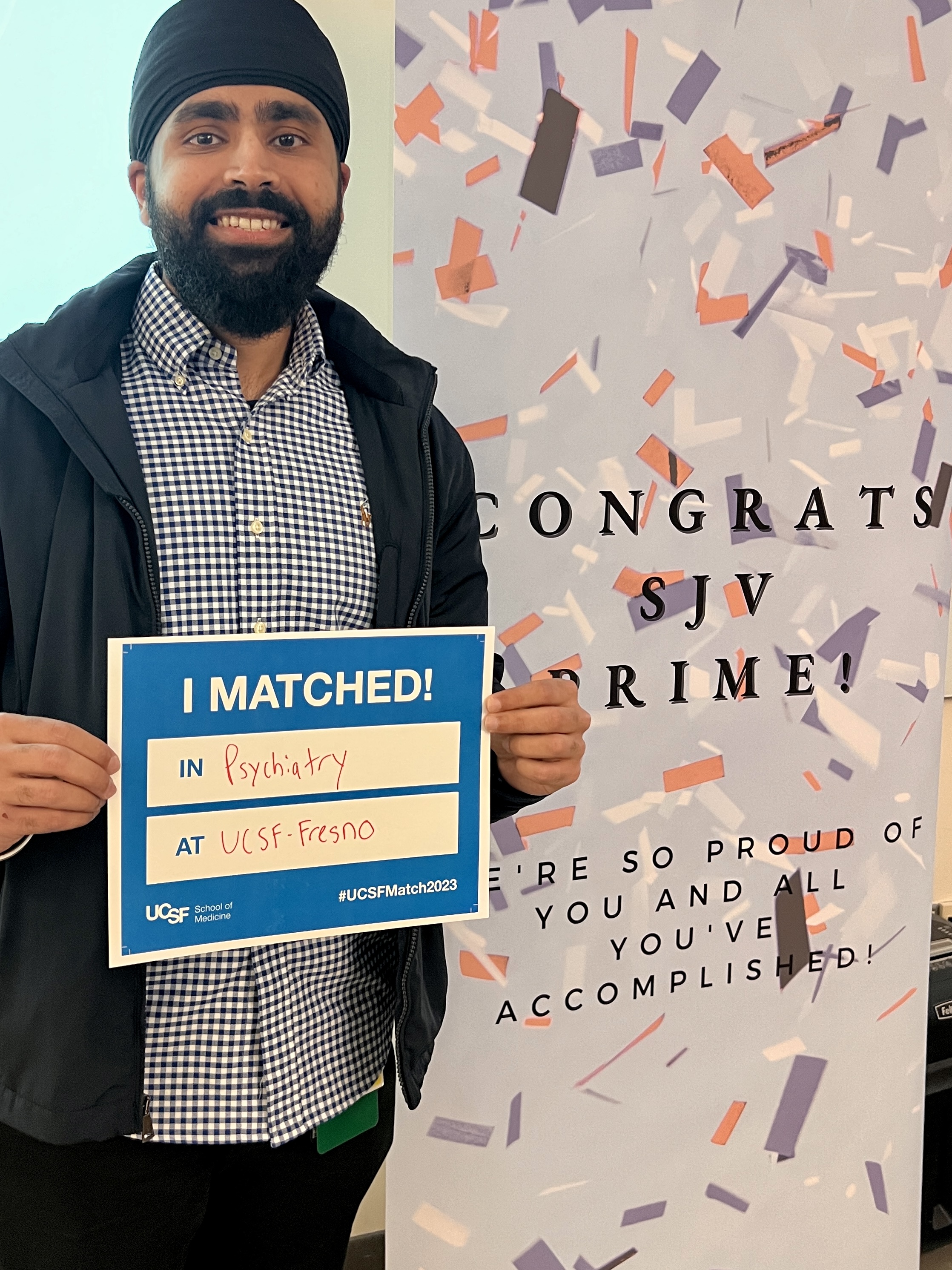 Man standing holding a sign that says "I matched"