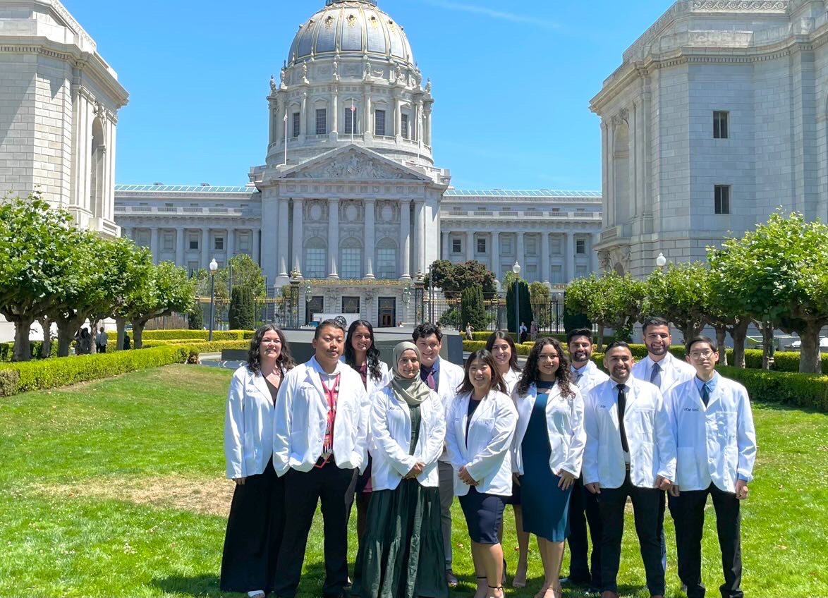 Group of medical students standing in front of historical building