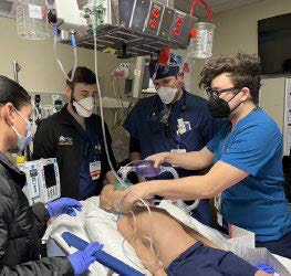 EM Residents training on dummy in hospital room