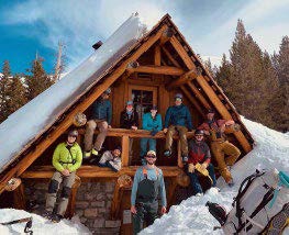 EM Residents outside cabin in the snow