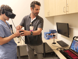 Fellow using virtual reality glasses for medical exercise