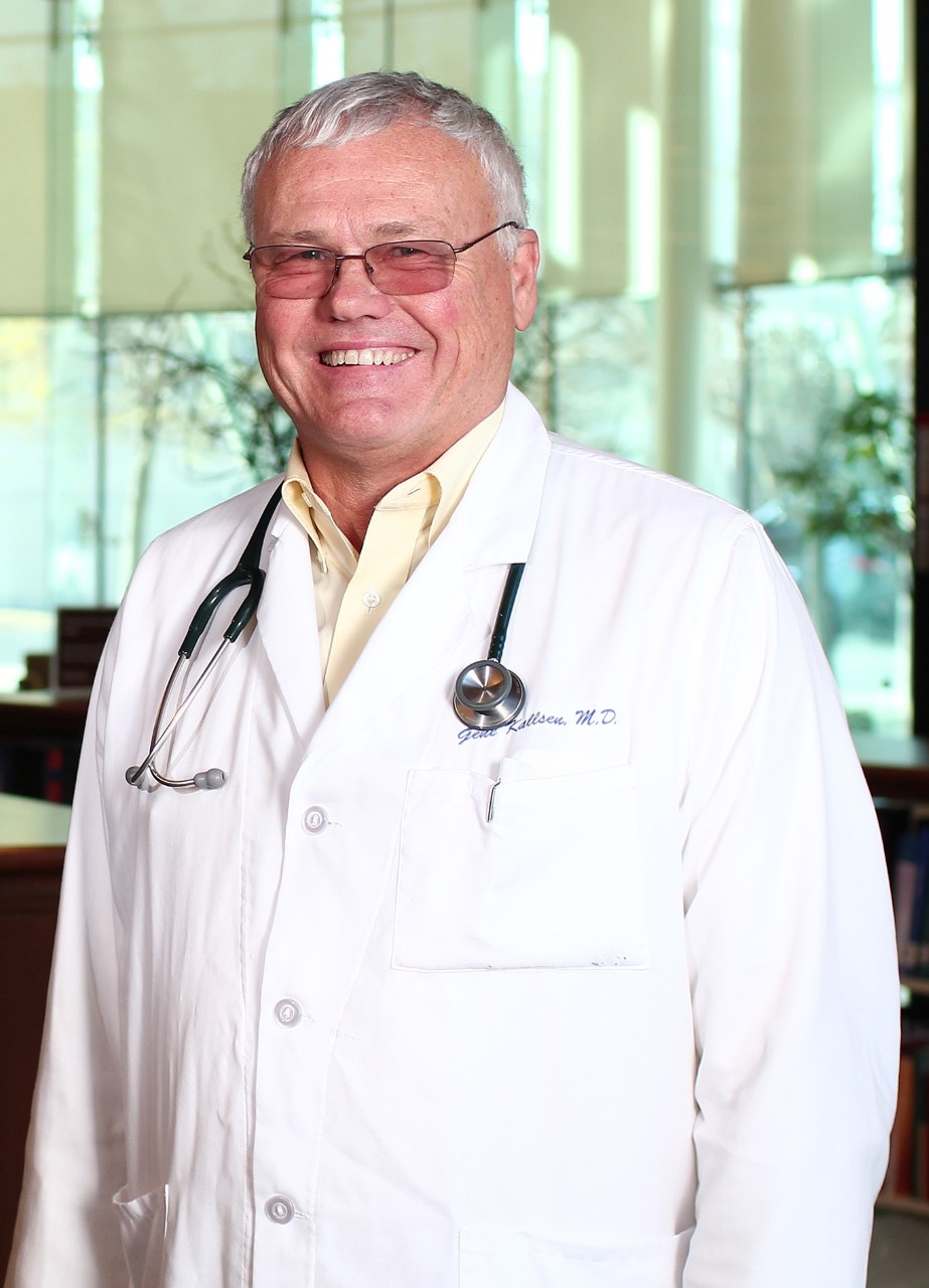 Dr. Gene Kallsen posing in his white coat in the UCSF Fresno Lobby