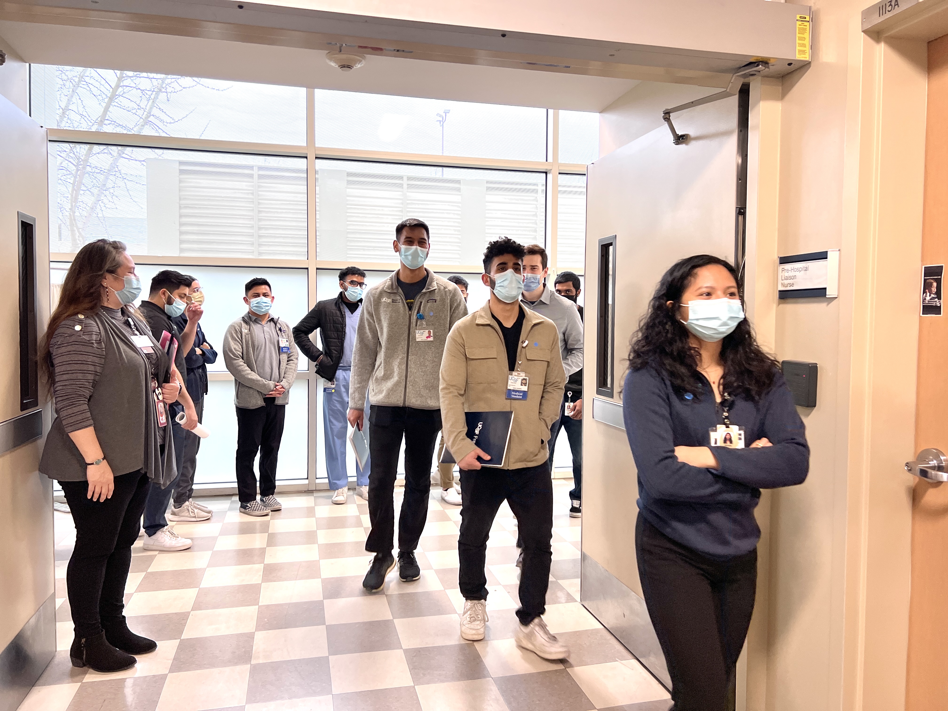 Group of medical students walking into a building hallway