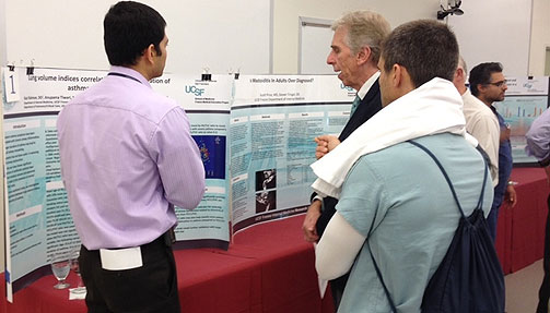 Residents discussing research poster projects