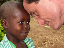 Doctor smiling at African Child